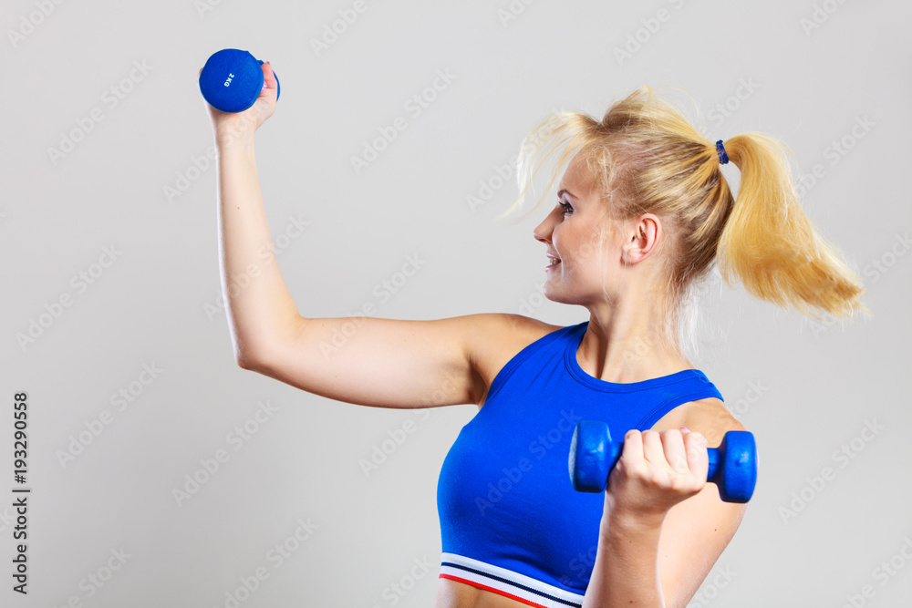 Fit woman lifting dumbbells weights Fit woman lifting dumbbells weights
