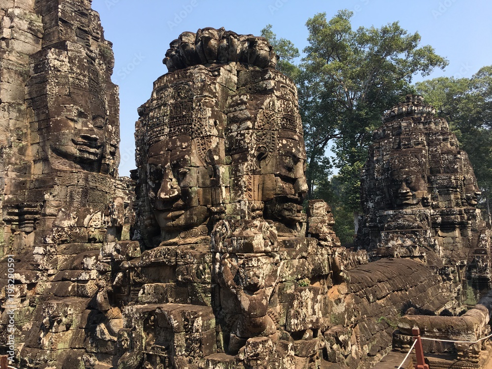 Angkor Wat in Siem Reap, Cambodia. Stone faces carved in the ancient ruins of Bayon Khmer Temple