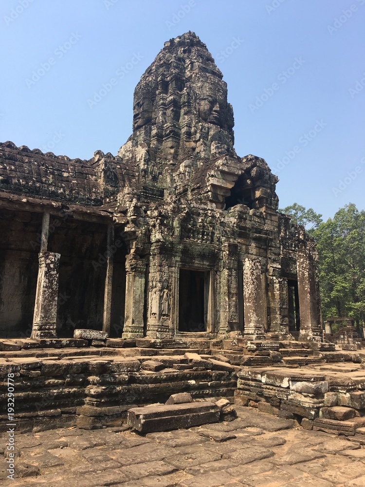 Angkor Wat in Siem Reap, Cambodia. Ancient ruins of Bayon Khmer stone temple in jungle forest. Angkor Wat in Siem Reap, Cambodia. Ancient ruins of Bayon Khmer stone temple in jungle forest.
