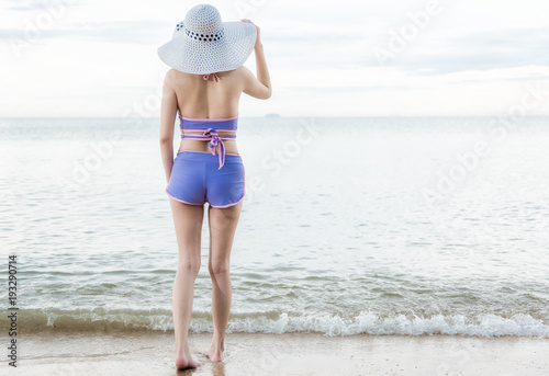 Portrait happy woman stand Helmeted on sand looking to sea