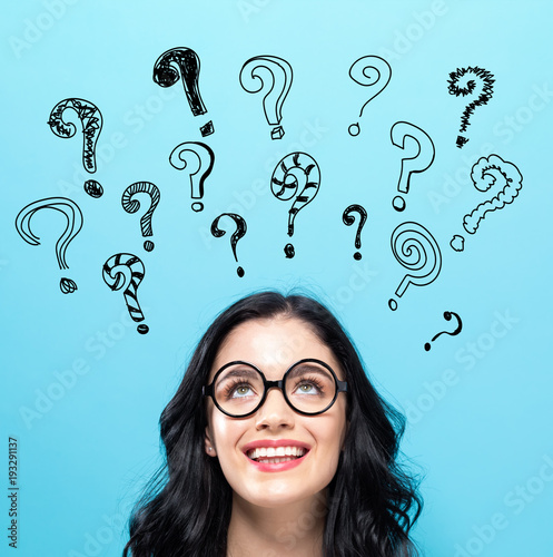 Question Marks with happy young woman on a blue background