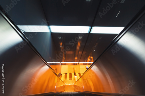 Motion blurred view of a moving escalator photo