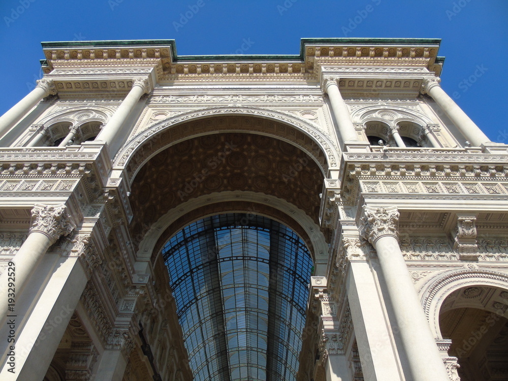Amazing photography to the high part of the Galleria Vittorio Emanuele in Milan with a great blue sky and some beautiful details of the structure