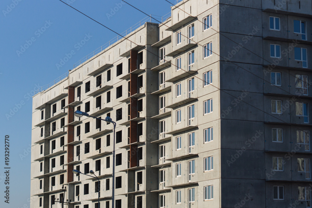 Construction of a multi-storey building on blue sky background Construction of a multi-storey building on blue sky background