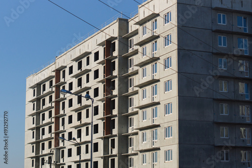 Construction of a multi-storey building on blue sky background