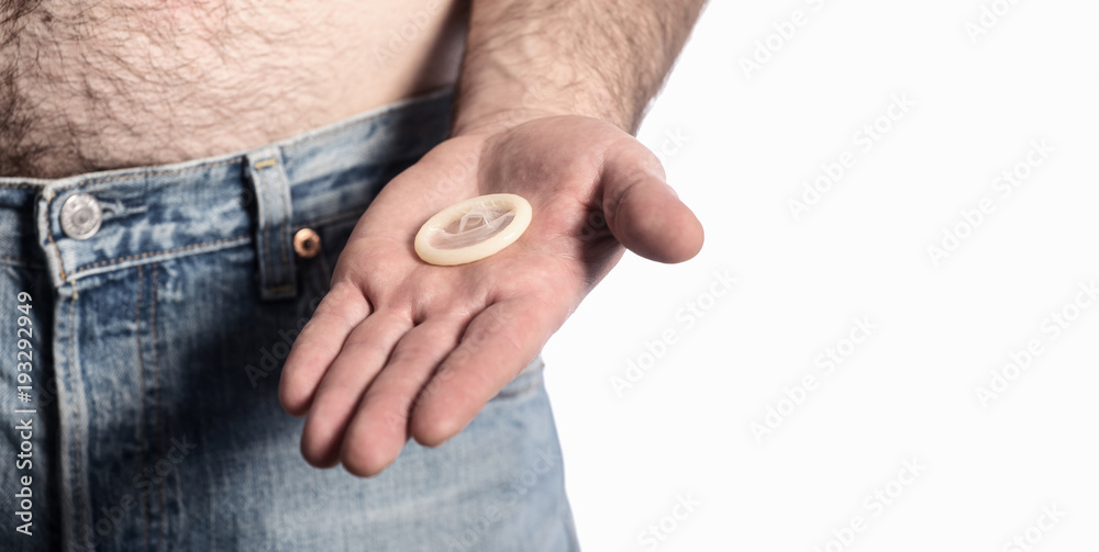 Fototapeta premium safe sex concept , holding condom in hand 