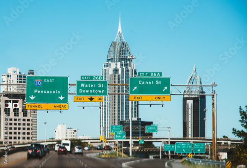 highway city view of pensacola, florida, skyline from the highway with big road street signs and high houses photo