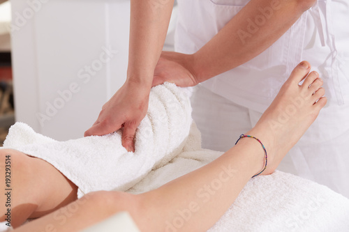 Female Enjoying Relaxing legs Massage In Cosmetology Spa Center