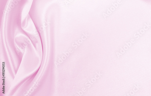 Smooth elegant pink silk or satin texture as wedding background. Luxurious valentine day background design