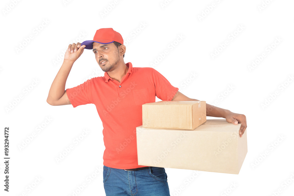 Delivery man holding carton boxes hand on cap in uniform Delivery man holding carton boxes hand on cap in uniform
