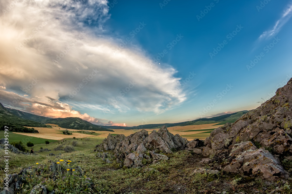 Fototapeta premium Beautiful landscape of a dramatic sky above rocky mountains, Dobrogea, Romania