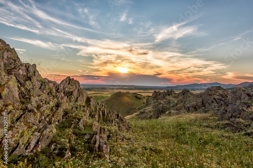 Beautiful landscape of a colorful sunset sky above rocky mountains, Dobrogea, Romania