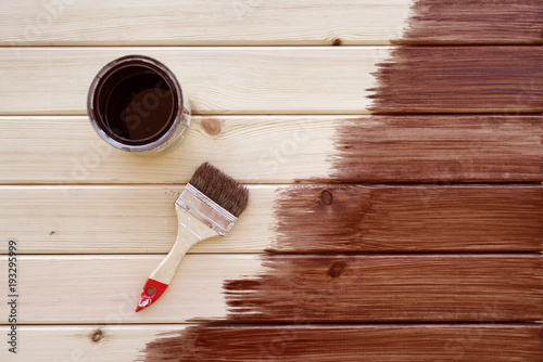 Painting a wooden shelf using paintbrush