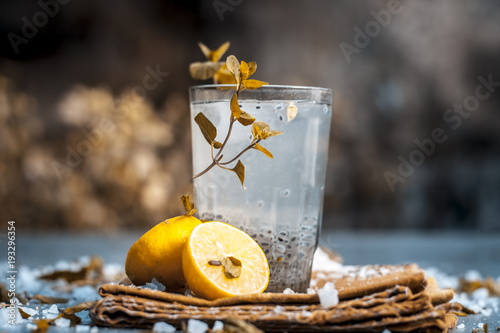 Indian popular summer drink SABJA NIMBUPANI/SWEET BASIL DRINK WITH LEMON and sugar in dark Gothic colors on a wooden surface.; photo