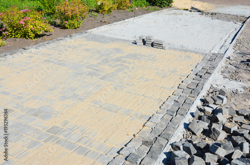 Close up on installing pavers for garden pathway with copy space.