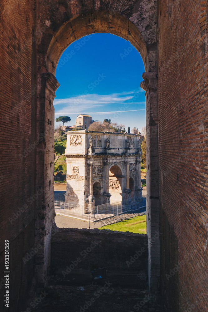 Fototapeta premium Arch of Constantine landmark and the symbol of Rome as seen from inside the Roman Colosseum