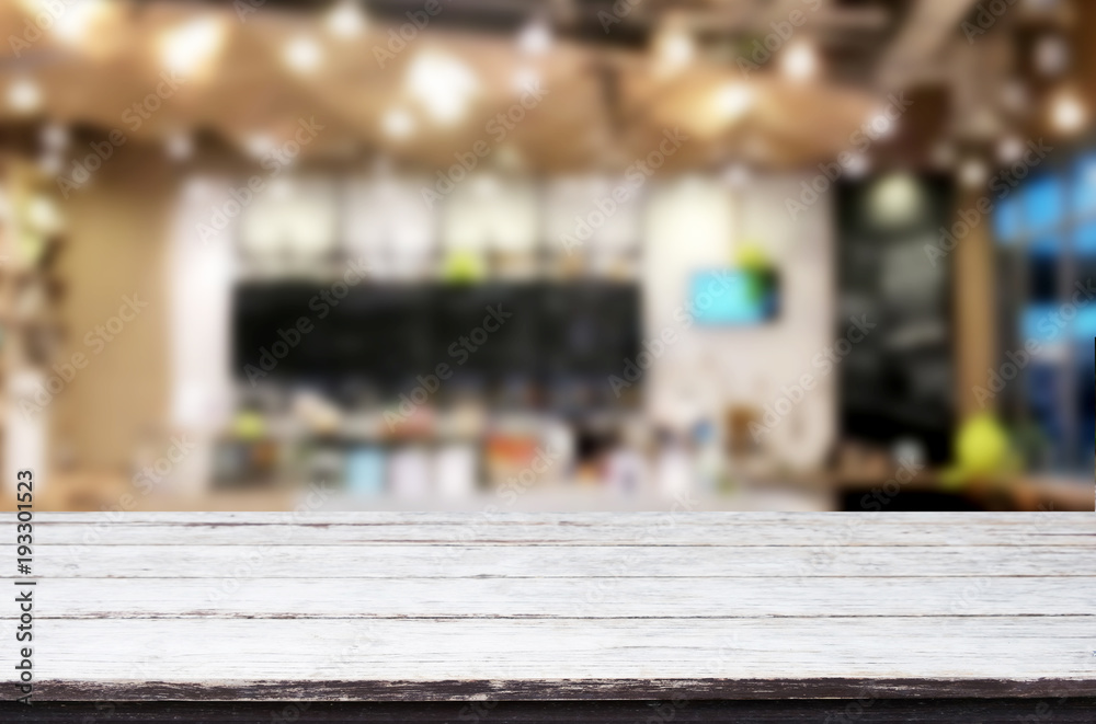 Selected focus empty brown wooden table and Coffee shop or restaurant blur background with bokeh image. for your photomontage or product display. Selected focus empty brown wooden table and Coffee shop or restaurant blur background with bokeh image. for your photomontage or product display.