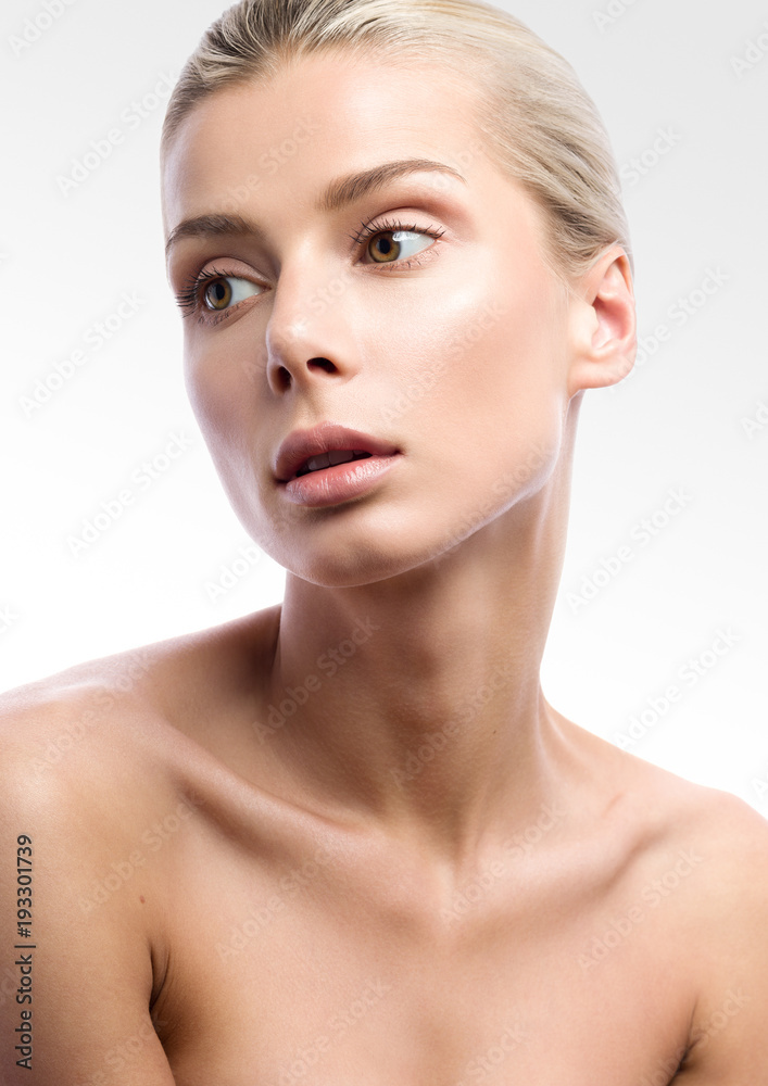 Beauty portrait of beautiful young woman on light grey background. Nude make-up. Beauty portrait of beautiful young woman on light grey background. Nude make-up.