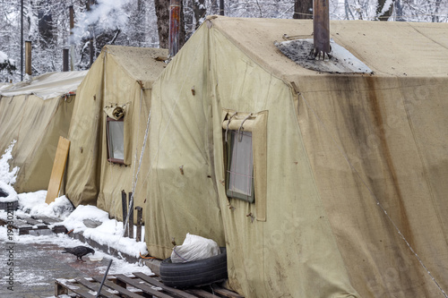 Campground protesters with wooden barricades and automotive rubber for setting fire. © anatoliiSushko