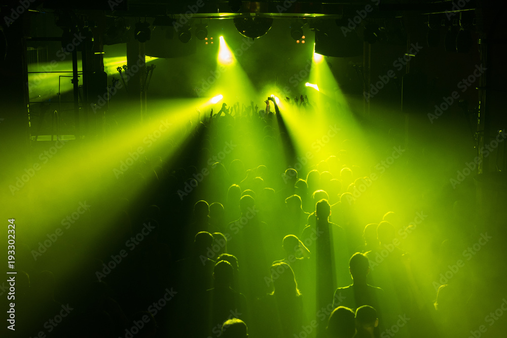 Rock concert crowd people in front of the bright stage lights Stock