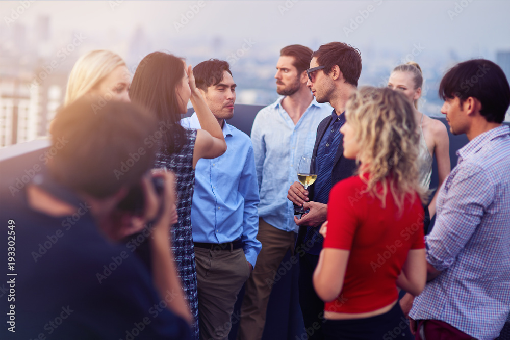 Young people having a corporate party on the rooftop