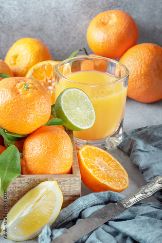 Fresh fruits. Citrus background. Mandarin, lime, tangerine, lemon and juice glass photo