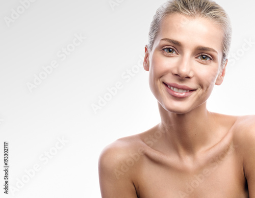 Beauty portrait of beautiful young woman with a kind smile. Closeup portrait of free space