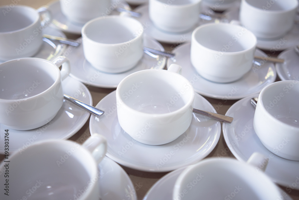 a group set of white ceramic coffee cups to prepare for a coffee time in the afternoon. a group set of white ceramic coffee cups to prepare for a coffee time in the afternoon.