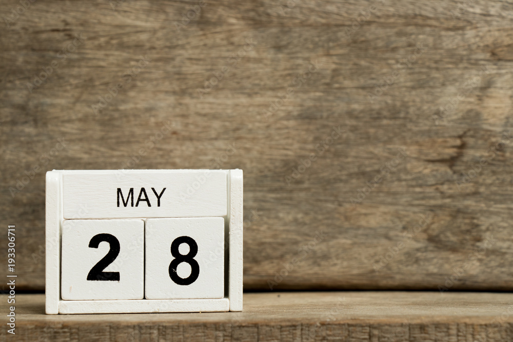 White block calendar present date 28 and month May on wood background White block calendar present date 28 and month May on wood background