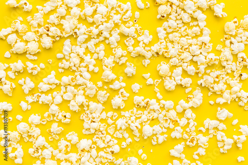 Popcorn background on yellow top view copy space