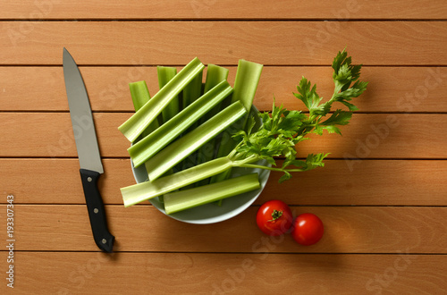 celery cut with tomato and knife beside