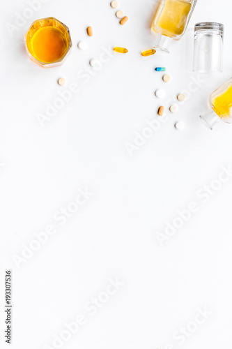 Alocohol abuse and alcoholism treatment concept. Glasses, bottles and medcine pills on white background top view copy space photo