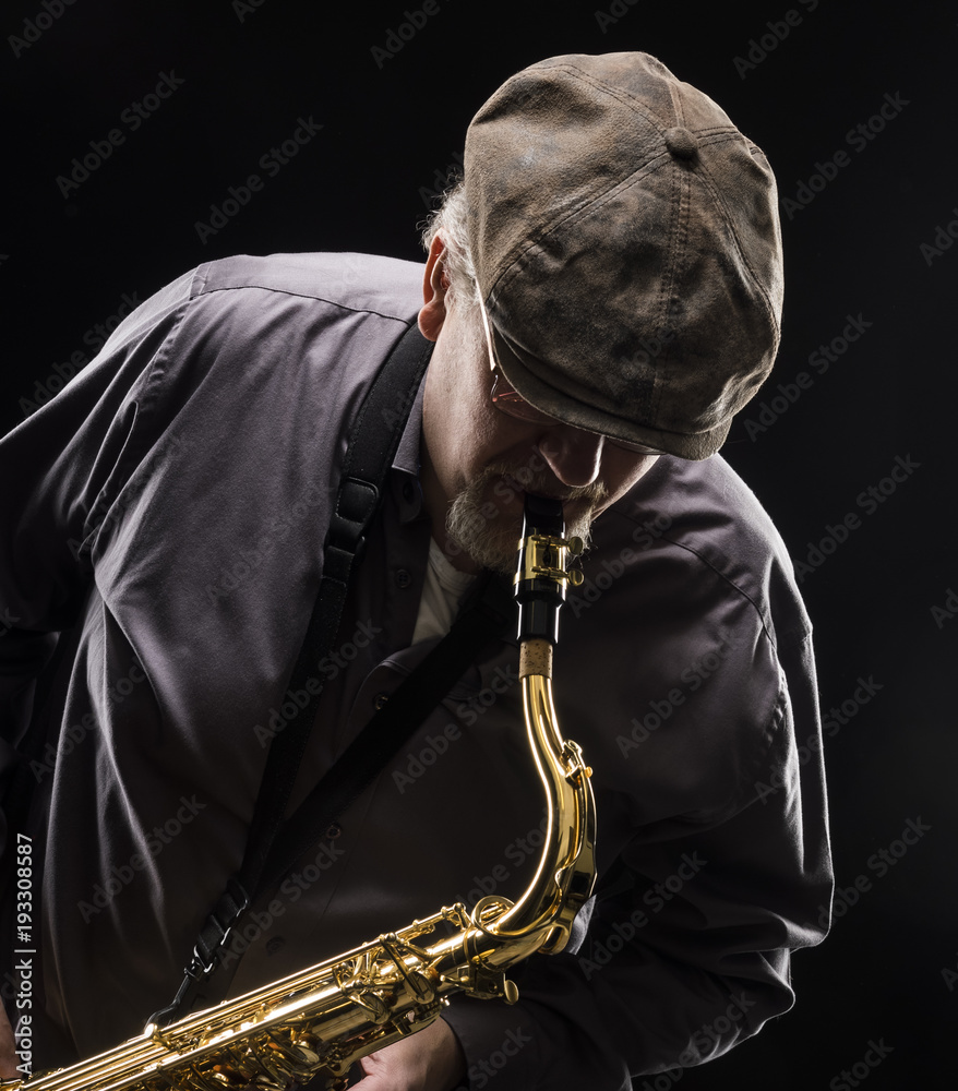 Naklejka premium Adult sax player with his instrument