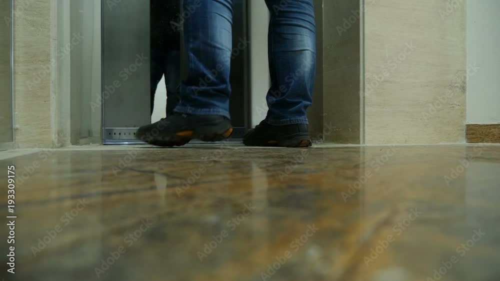 Man feet entering the elevator. Unrecognisable person Man feet entering the elevator. Unrecognisable person