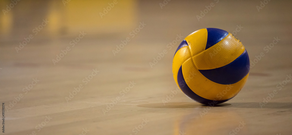 Volleyball ball on blurred wooden parquet background. Banner, space for text, close up view with details. - obrazy, fototapety, plakaty 