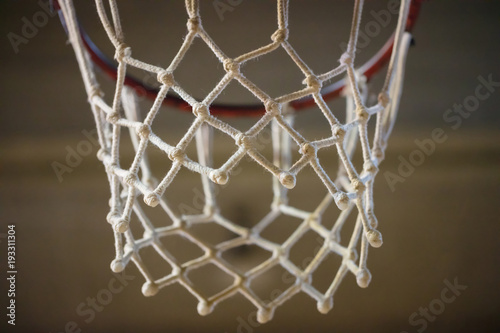 Basketball hoop with white net. Blurred background  close up view with details.