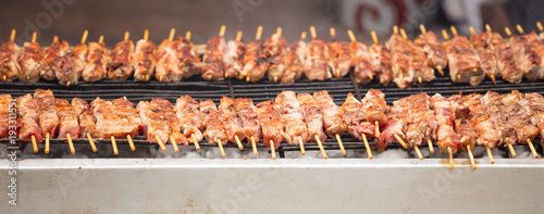 Meat skewers souvlaki on grill. Close up, banner, front view with details.