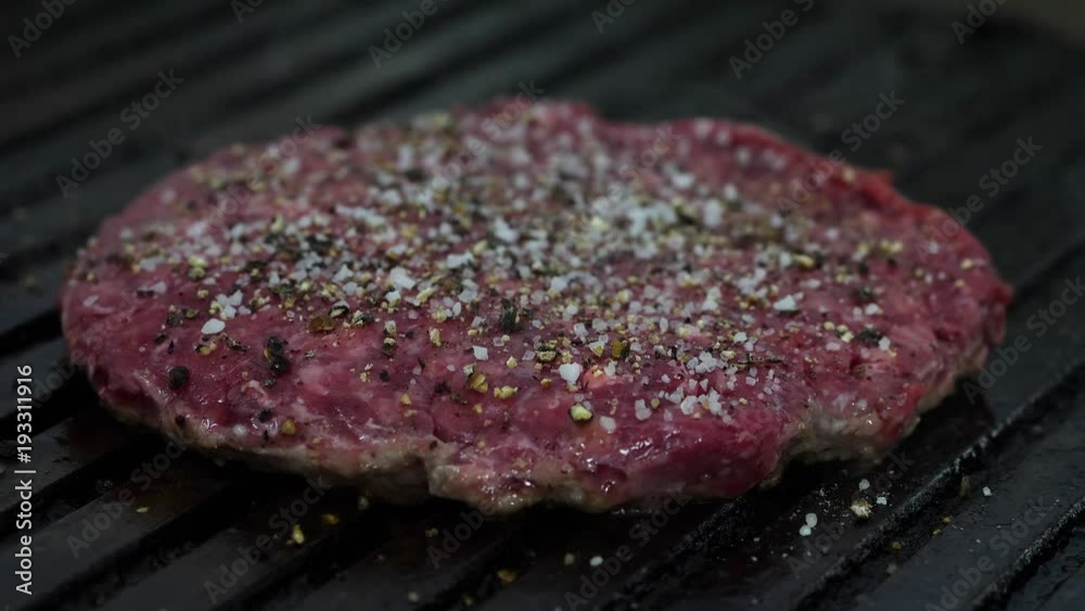 Burger flipped on the stone grill. Preparing of the burger Burger flipped on the stone grill. Preparing of the burger