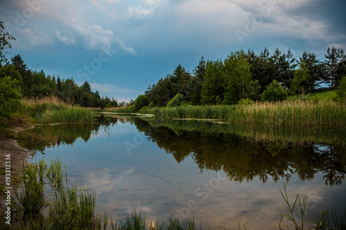 Calm river flowing gently through woodland landscape. Location Lagen in Belarus