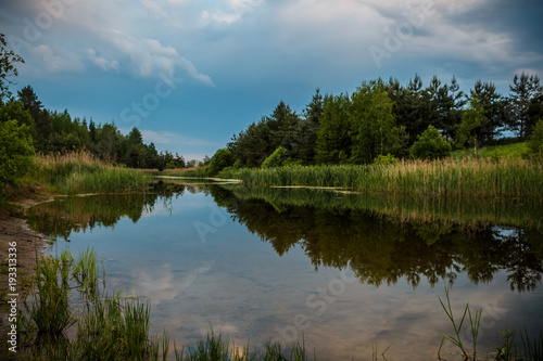 Calm river flowing gently through woodland landscape. Location  Lagen in Belarus