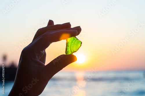 sea smoothed green glass in hand