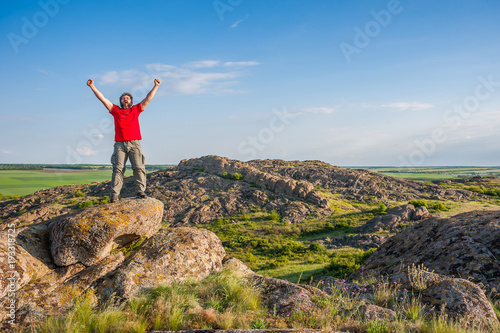 Happy hiker on mountain peak