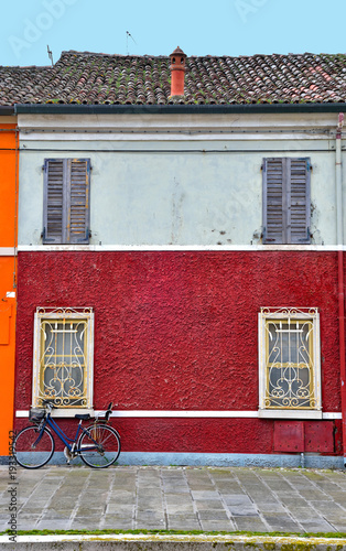 Small Italian town Comacchio also known as "The Little Venice", Emilia Romagna region, province of Ferrara, Italy: Colored houses in traditional architectural style