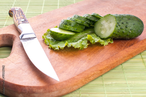 Fresh and sliced cucumbers. Sliced cucumbers on a cutting board. cucumbers for diet and healthy eating. photo