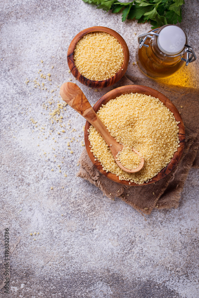 Couscous grain in wooden bowl Couscous grain in wooden bowl