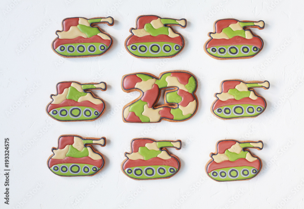 Homemade Gingerbreads in the form of tanks in protective khaki color on Defender of the Fatherland Day. Selective focus. Homemade Gingerbreads in the form of tanks in protective khaki color on Defender of the Fatherland Day. Selective focus.