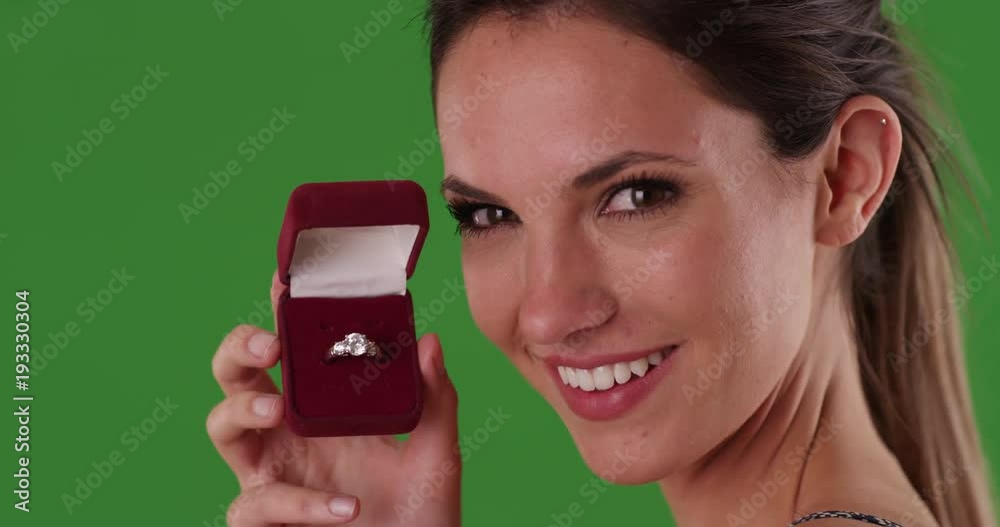 Smiling woman holding diamond engagement ring in jewelry box on greenscreen. happy millennial girl in her 20s with beautiful gift. 4k on green for keying or compositing Smiling woman holding diamond engagement ring in jewelry box on greenscreen. happy millennial girl in her 20s with beautiful gift. 4k on green for keying or compositing