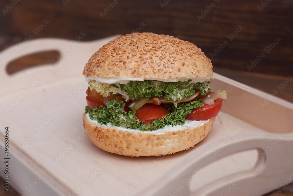 Homemade Burger in Wooden box, with fresh Vegetables on rustic Wooden Background with copy Space. Rustic Fast food. Homemade Burger in Wooden box, with fresh Vegetables on rustic Wooden Background with copy Space. Rustic Fast food.