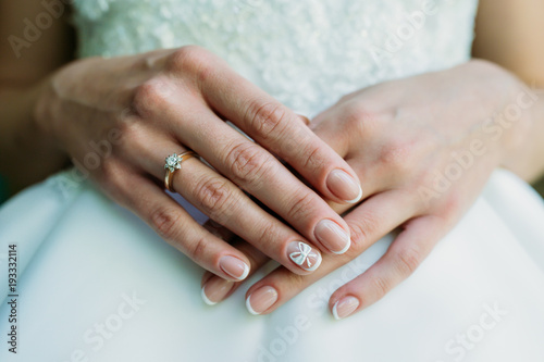 Bride in white wedding dress . Hands of the bride.