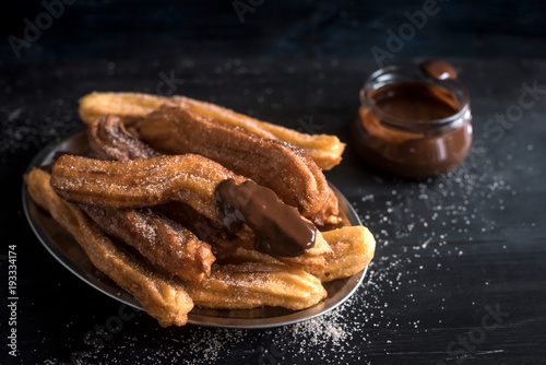 Close up to traditional Mexican dessert churros with chocolate,selective focus